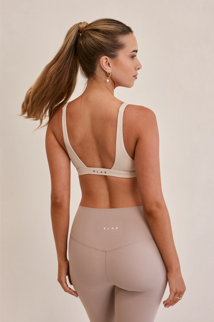 Model wearing YLab Luna Lift Sports Bra in Cream