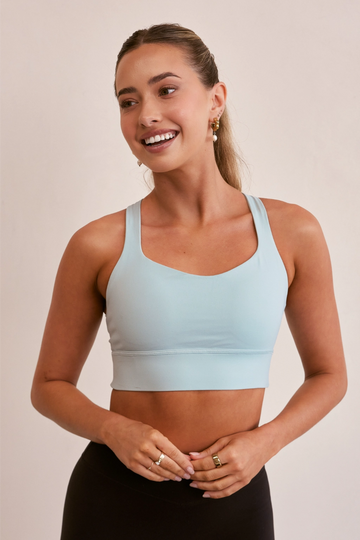 Model wearing Pure Elevation Sports Bra in Sky Blue